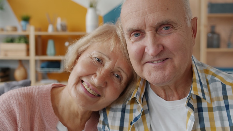 Mature couple smiling confidently at home while reviewing retirement plans
